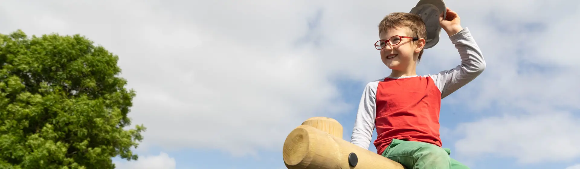 Child sitting on top of play equipment