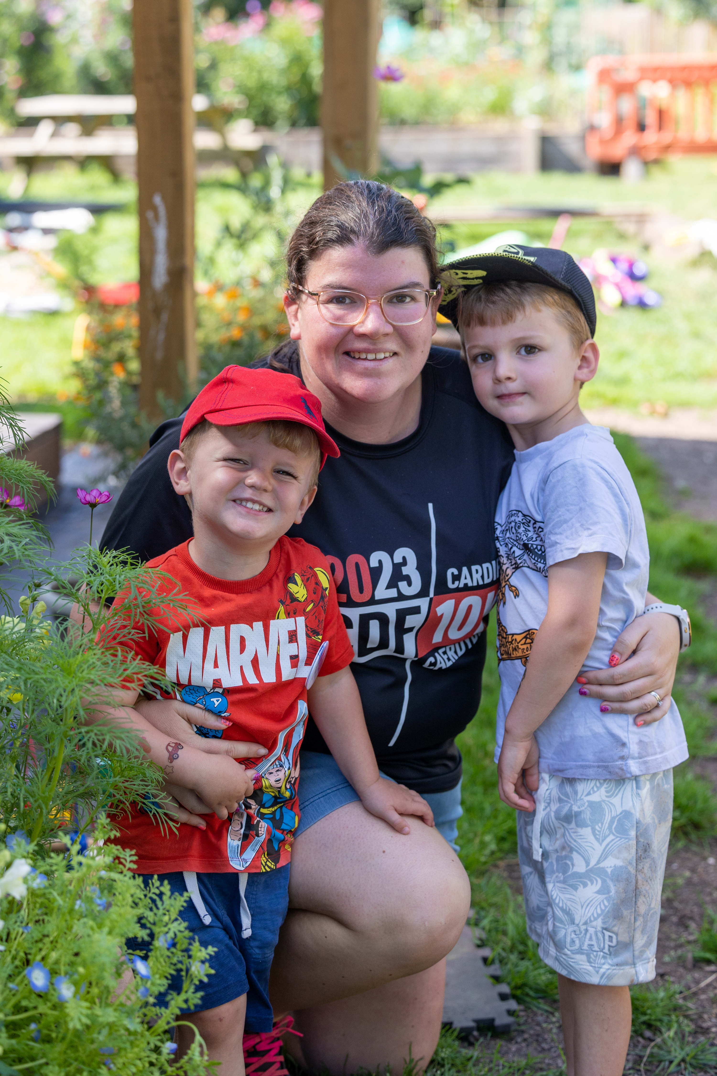 Mum hugging her two sons on allotment