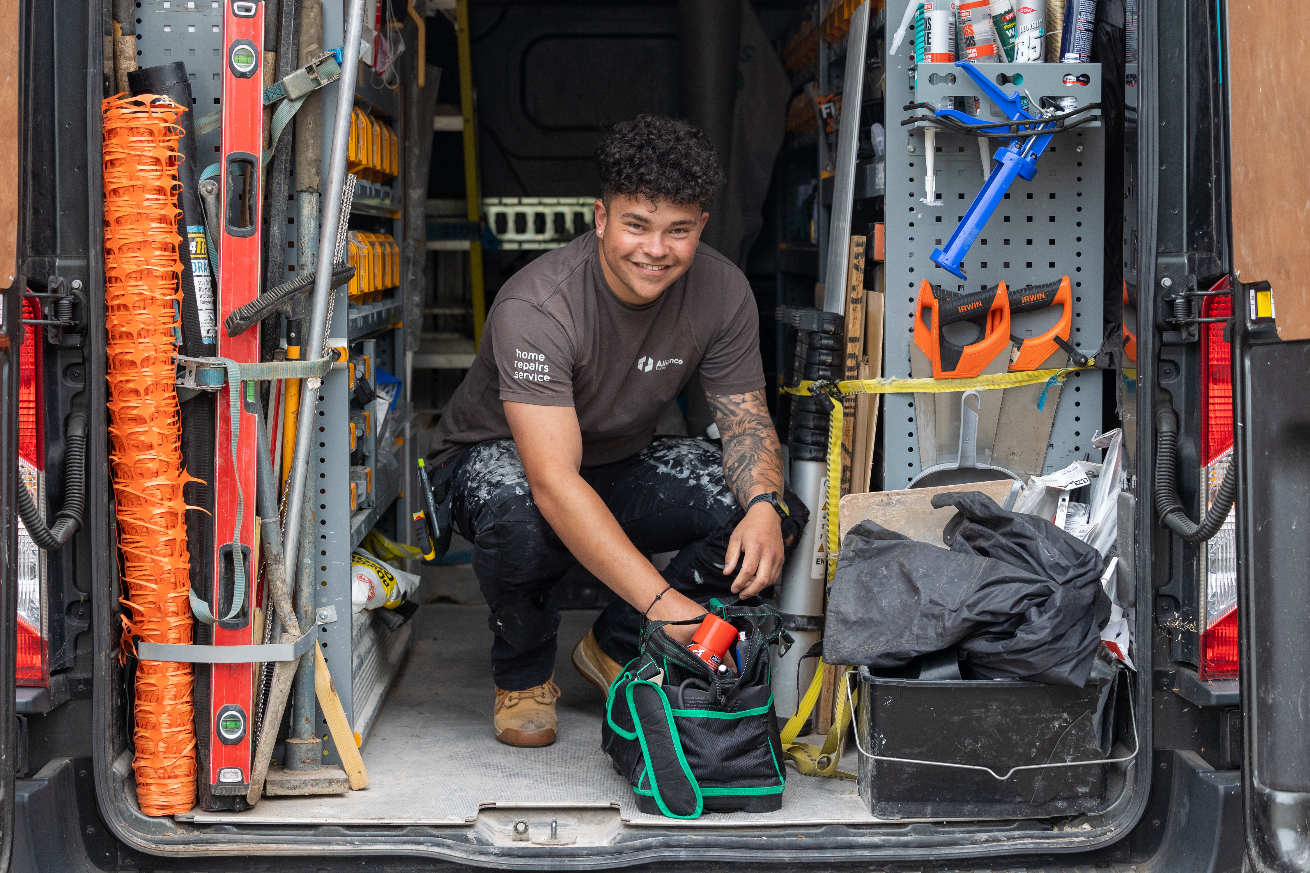Man in back of van surrounded by tools