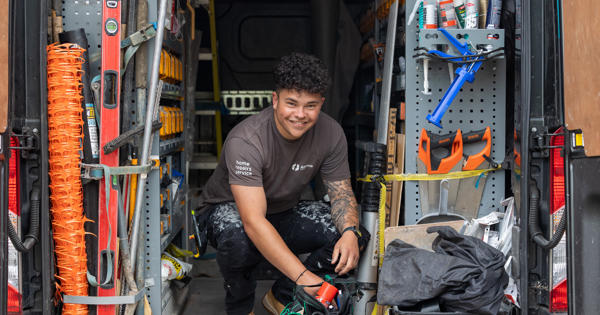 Man in back of van surrounded by tools
