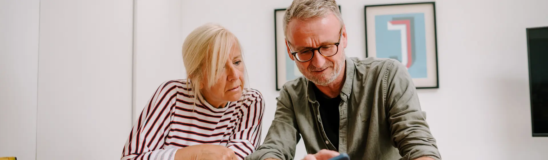 man and women looking at phone