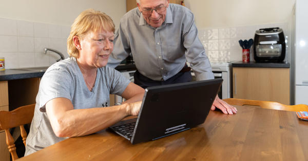 customers looking at laptop