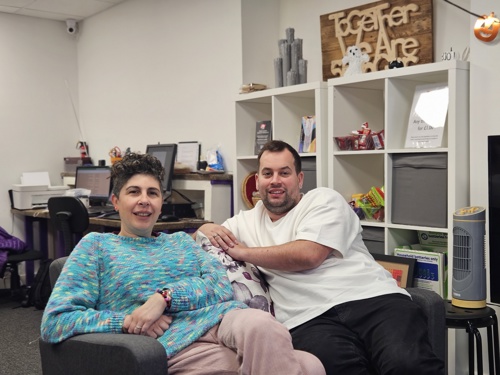 Two people sitting on chairs