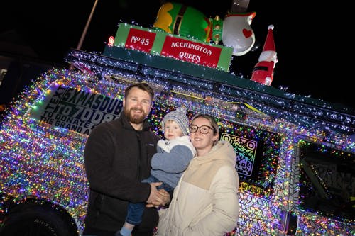 Family standing in front of a Christmas Dubs van.