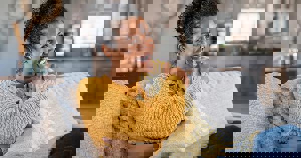woman sat on couch at home