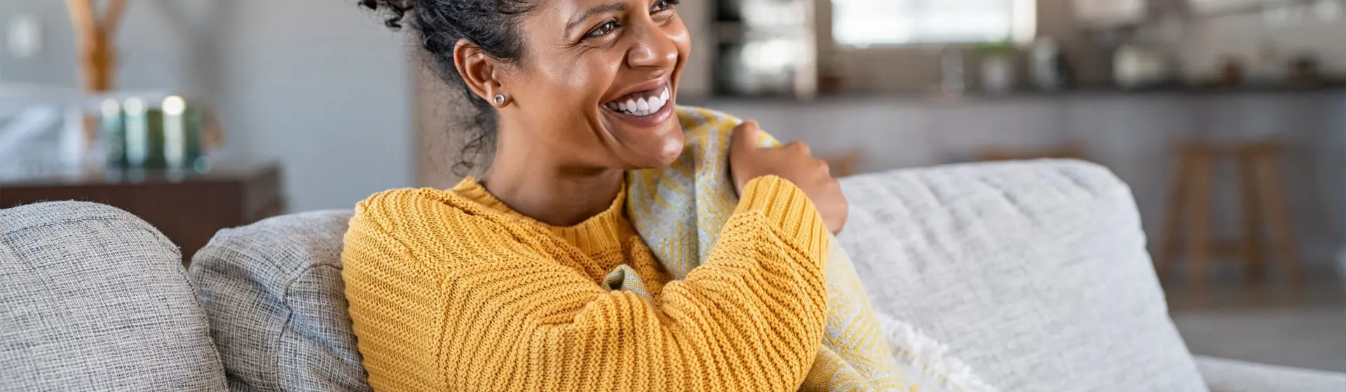 woman sat on couch at home