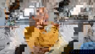 woman sat on couch at home