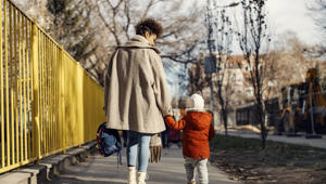 Mother And Child Walking Down A Street