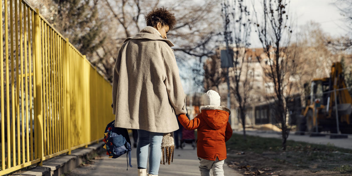 Mother And Child Walking Down A Street