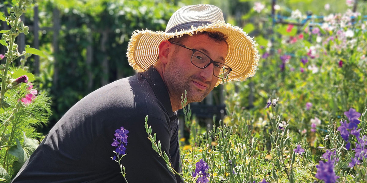 Image of man in hat gardening