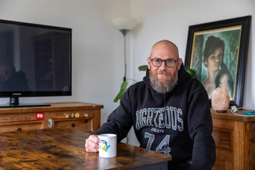 Man in dining room with mug