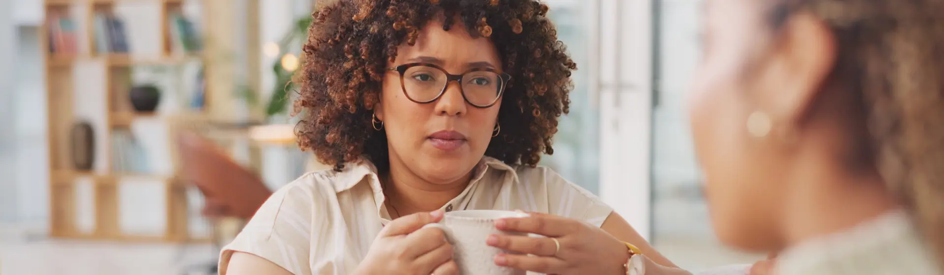 Woman with glasses drinking from cup