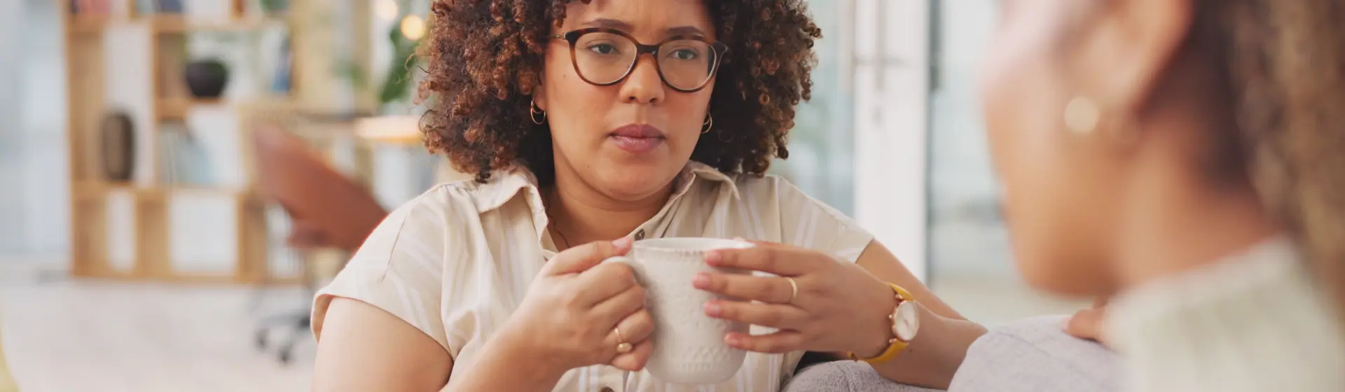 Woman with glasses drinking from cup
