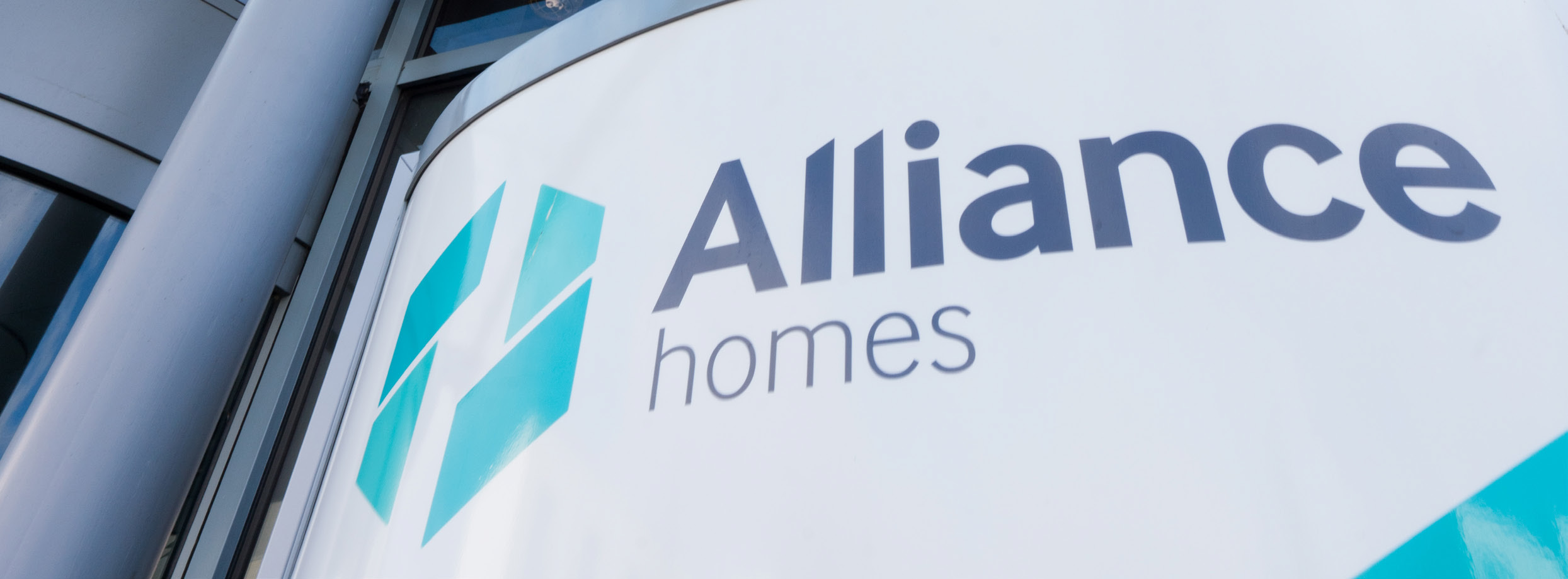 Sign with Alliance Homes written on it. 