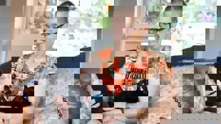 woman looking at phone with pet rabbit