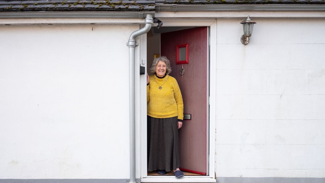 Lady Wearing A Jumper At Their Front Door