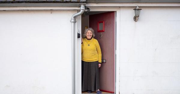 Lady Wearing A Jumper At Their Front Door