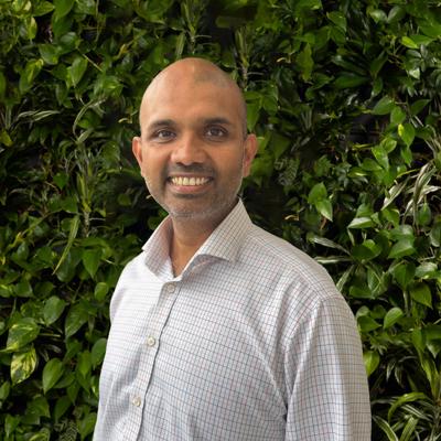 Image of man against a background of leaves