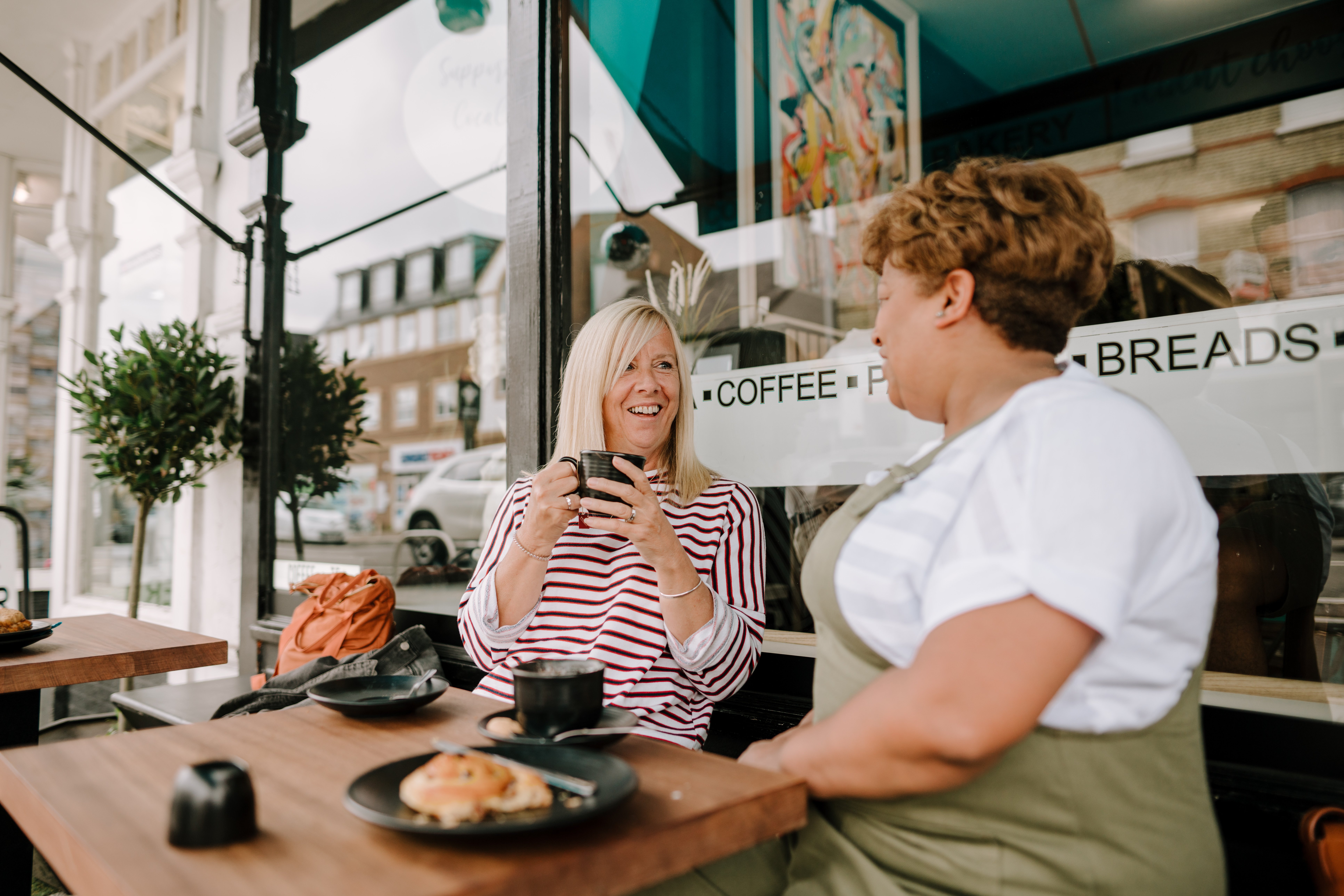 two women having coffee and talking