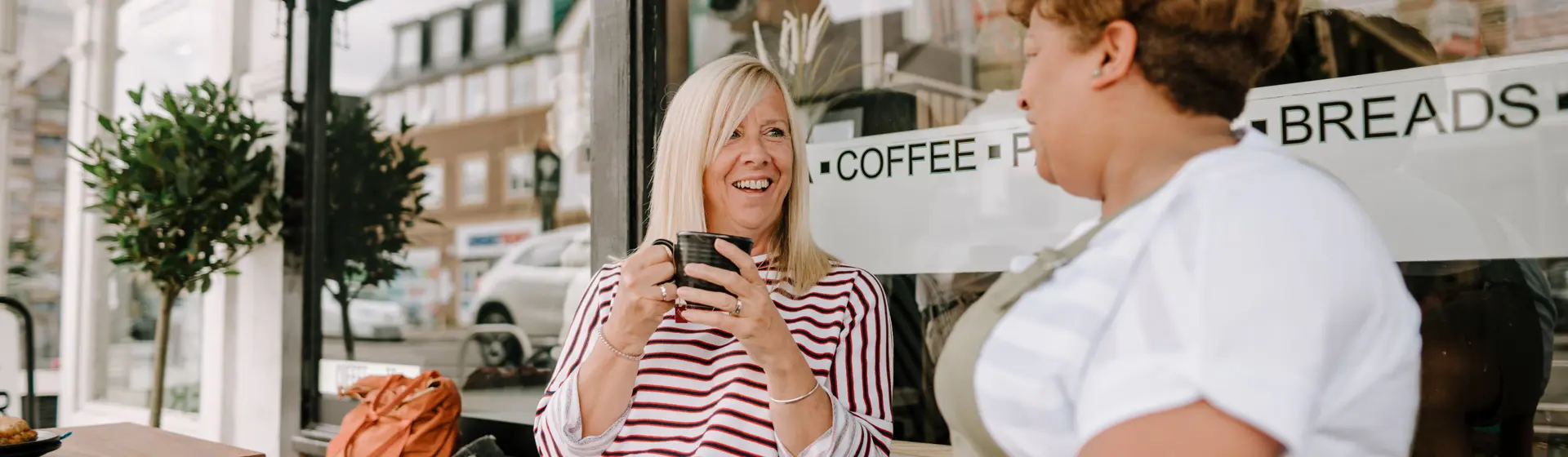 two women having coffee and talking